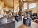 Open-concept living room with a cozy fireplace and exposed beams at 855 E Ponderosa Rd, Mammoth Creek, UT 84735