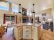 Inviting living room with stone fireplace, wood floors, wooden kitchen island and a gorgeous view of the surrounding wilderness at 855 E Ponderosa Rd, Mammoth Creek, UT 84735