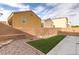 Backyard featuring a concrete patio, artificial turf, and a low brick perimeter wall at 9100 Balcony Trellis Ave, Las Vegas, NV 89149