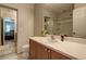 Bathroom featuring single sink vanity, framed mirror, and a glass shower enclosure at 9100 Balcony Trellis Ave, Las Vegas, NV 89149