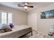 Comfortable bedroom features neutral tones, plantation shutters, and an entertainment center at 9100 Balcony Trellis Ave, Las Vegas, NV 89149
