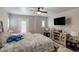 Comfortable bedroom featuring a ceiling fan, plush bedding and decor and a private exterior door at 9100 Balcony Trellis Ave, Las Vegas, NV 89149