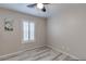 Neat bedroom showcasing plantation shutters, light hardwood floors, and ample natural light at 9100 Balcony Trellis Ave, Las Vegas, NV 89149