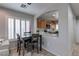 Bright dining area featuring modern shutters, with open view into the kitchen at 9100 Balcony Trellis Ave, Las Vegas, NV 89149