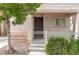 Charming front porch with iron work leading to the front door and desert landscaping at 9100 Balcony Trellis Ave, Las Vegas, NV 89149