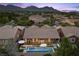 An aerial shot shows the home, backyard pool with inset spa, and desert landscaping at 940 Viscanio Pl, Las Vegas, NV 89138