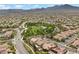 Scenic aerial view showcases a beautiful community with lush greenery and nearby mountain views at 940 Viscanio Pl, Las Vegas, NV 89138