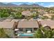 Inviting backyard featuring a modern pool, lounge area, and lush landscaping perfect for outdoor living at 940 Viscanio Pl, Las Vegas, NV 89138