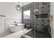 Beautifully designed bathroom featuring a standalone tub, glass-enclosed shower, and striking patterned tile at 940 Viscanio Pl, Las Vegas, NV 89138