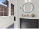 Stylish powder room featuring a round mirror, modern vanity and brushed gold faucet at 940 Viscanio Pl, Las Vegas, NV 89138