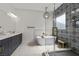 Modern bathroom features a sleek vanity with dual sinks, standalone tub, and glass enclosed shower at 940 Viscanio Pl, Las Vegas, NV 89138