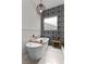 Elegant bathroom features a freestanding tub with gold fixtures and striking black and white patterned tiling at 940 Viscanio Pl, Las Vegas, NV 89138