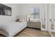 Bright bedroom features a stylish bed frame, wood-look floors, and mirrored closet doors at 940 Viscanio Pl, Las Vegas, NV 89138