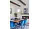 Close-up of dining room showcasing the fireplace and modern wooden table with blue chairs at 940 Viscanio Pl, Las Vegas, NV 89138