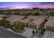A front exterior view shows the home's desert landscaping and neighborhood surroundings at dusk at 940 Viscanio Pl, Las Vegas, NV 89138