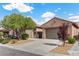 Attractive single-story home with desert landscaping, a three-car garage, and charming curb appeal at 940 Viscanio Pl, Las Vegas, NV 89138
