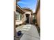 Home's front entrance featuring desert landscaping, a tiled roof, and a glass-paneled door at 940 Viscanio Pl, Las Vegas, NV 89138