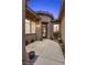 Home's front entrance has desert landscaping, a tiled roof, and a glass-paneled door at 940 Viscanio Pl, Las Vegas, NV 89138
