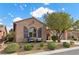 Charming home with a well-manicured lawn, decorative shutters and inviting front porch seating area at 940 Viscanio Pl, Las Vegas, NV 89138