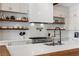 Contemporary kitchen featuring wooden shelves, modern appliances, white cabinets, and a wood-topped island at 940 Viscanio Pl, Las Vegas, NV 89138