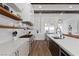 Spacious kitchen with open shelving, stainless steel appliances, and a view into the dining area at 940 Viscanio Pl, Las Vegas, NV 89138