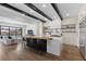 Modern kitchen with wooden beam ceiling, waterfall island and stainless steel appliances at 940 Viscanio Pl, Las Vegas, NV 89138