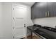 Well-equipped laundry room features modern washer and dryer and upper cabinets for storage at 940 Viscanio Pl, Las Vegas, NV 89138
