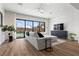 Bright and airy living room with modern furnishings, large windows, and access to the backyard pool at 940 Viscanio Pl, Las Vegas, NV 89138