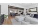Open-concept living room with view into the kitchen and dining area with wooden beam ceiling at 940 Viscanio Pl, Las Vegas, NV 89138