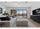 A cozy living room with sleek furniture, offering views of the inviting pool and well-maintained backyard at 940 Viscanio Pl, Las Vegas, NV 89138