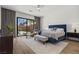 Serene main bedroom with neutral tones, ample natural light, and a sliding glass door to the backyard at 940 Viscanio Pl, Las Vegas, NV 89138