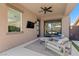 Covered patio with plush seating and views of the backyard, featuring desert landscaping at 940 Viscanio Pl, Las Vegas, NV 89138