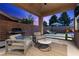 Beautiful patio with seating area, grill, and view of backyard with lawn and privacy wall at 940 Viscanio Pl, Las Vegas, NV 89138
