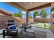 Inviting outdoor patio with comfortable seating, grill and views of the landscaped backyard at 940 Viscanio Pl, Las Vegas, NV 89138
