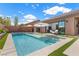 Sparkling pool with tanning ledge, surrounded by artificial turf and patio space with lounge seating at 940 Viscanio Pl, Las Vegas, NV 89138