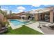 Backyard pool with tanning ledge, patio and artificial turf, with indoor/outdoor living space at 940 Viscanio Pl, Las Vegas, NV 89138