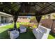 Backyard patio area with a gazebo, comfortable seating, and a well-manicured lawn at 9565 Camelback Creek Dr, Las Vegas, NV 89178