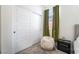 This is a bedroom featuring gray carpet, a window with a green curtain, and closet doors at 9565 Camelback Creek Dr, Las Vegas, NV 89178