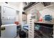 Organized closet with storage shelves and built-in washer and dryer at 9565 Camelback Creek Dr, Las Vegas, NV 89178