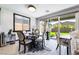 Charming dining area with a round table, stylish chairs, and sliding glass doors opening to the backyard, filled with natural light at 9565 Camelback Creek Dr, Las Vegas, NV 89178