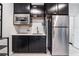 A well-equipped kitchenette with stainless steel appliances, black cabinets, and a sleek design at 9565 Camelback Creek Dr, Las Vegas, NV 89178