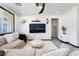 Bright living room with a comfortable sofa, modern decor, and a large TV screen for entertainment, offering a cozy atmosphere at 9565 Camelback Creek Dr, Las Vegas, NV 89178