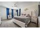 This is a spacious main bedroom featuring an upholstered bed, gray carpet, and modern decor accents at 9565 Camelback Creek Dr, Las Vegas, NV 89178
