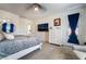 This is a main bedroom featuring gray carpet, a TV, and an upholstered bed with gray and white bedding at 9565 Camelback Creek Dr, Las Vegas, NV 89178