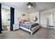 This is a main bedroom featuring an upholstered bed, gray carpet, and ensuite bathroom with walk-in shower at 9565 Camelback Creek Dr, Las Vegas, NV 89178