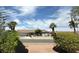 Charming single-story home featuring a well-maintained yard with palm trees and a white fence at , Las Vegas, NV 89121