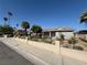 Lovely single-story home with a light-colored exterior, decorative front fence, and attractive landscaping at , Las Vegas, NV 89121