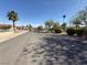 Peaceful street view with mature trees, landscaped yards, and well-maintained homes under a clear blue sky at , Las Vegas, NV 89121