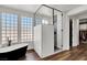 Contemporary bathroom featuring a glass shower, stand alone soaking tub, and large windows for natural light at , Las Vegas, NV 89135