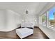 Bright bedroom featuring hardwood floors, white furniture and a view of the outdoors at , Las Vegas, NV 89135